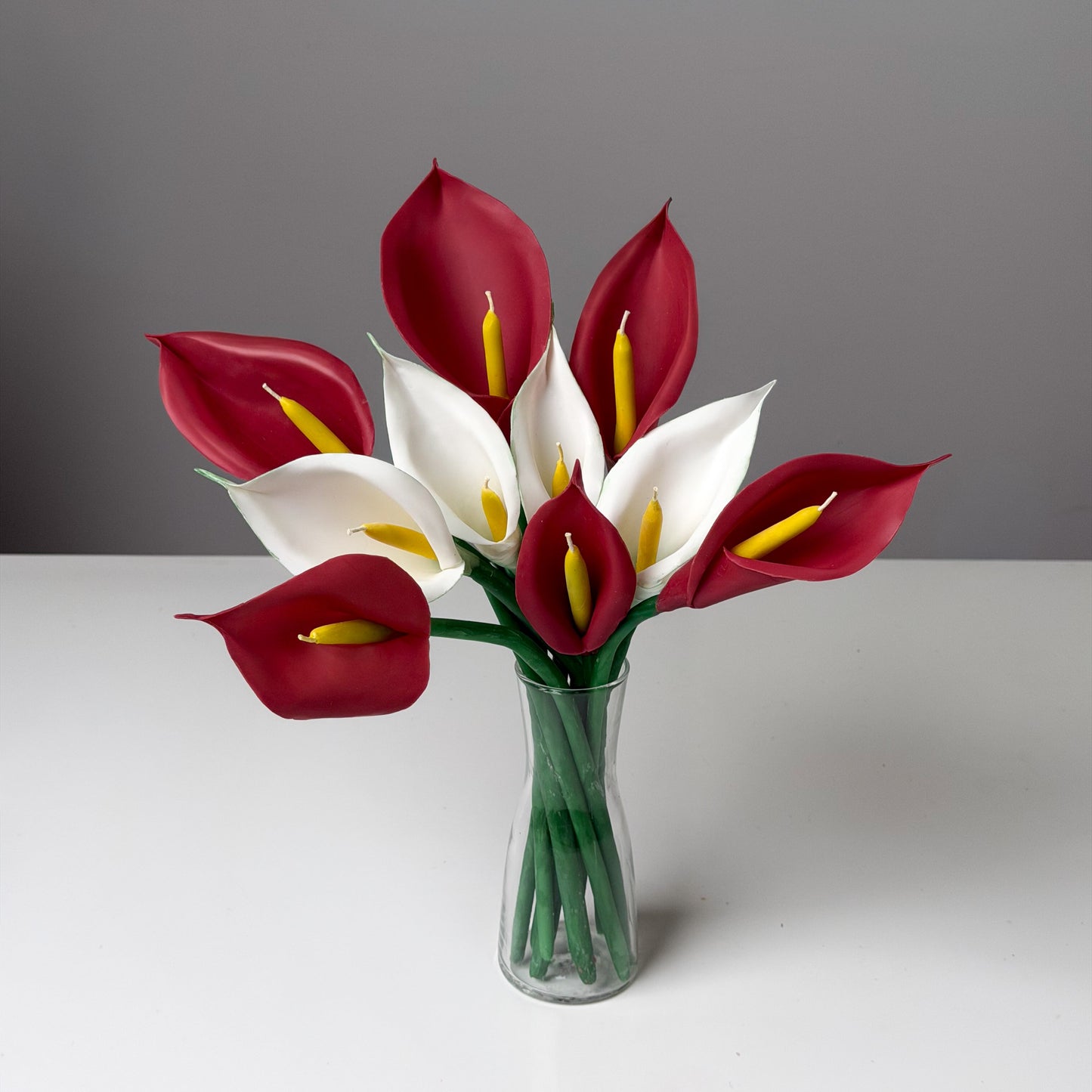 Bouquet of red and white calla lily candles in a clear vase - perfect gift