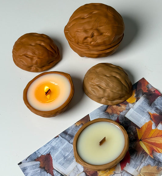 Walnut-shaped candle containers shown open and closed, with one candle burning.